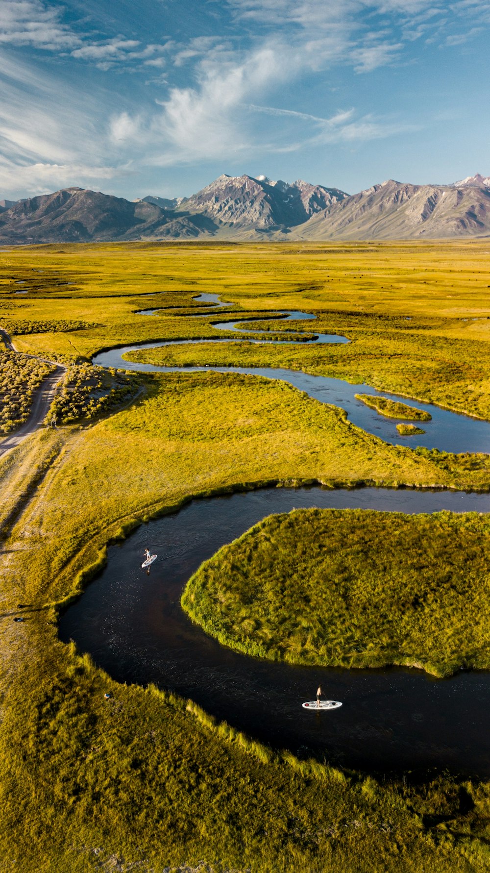 aerial view of green grass field and mountain during daytime