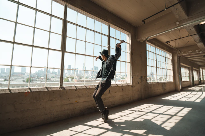 Jazz/tap dancer in profile on concrete floor, full-body silhouette