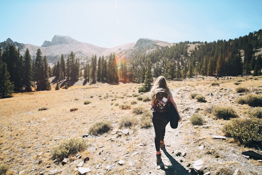 woman with a backpack hiking in the mountains