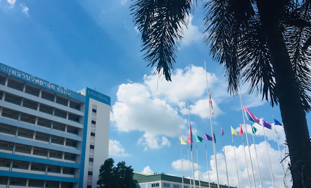 The consulate building adorned with Jamaican flags under a bright blue sky.