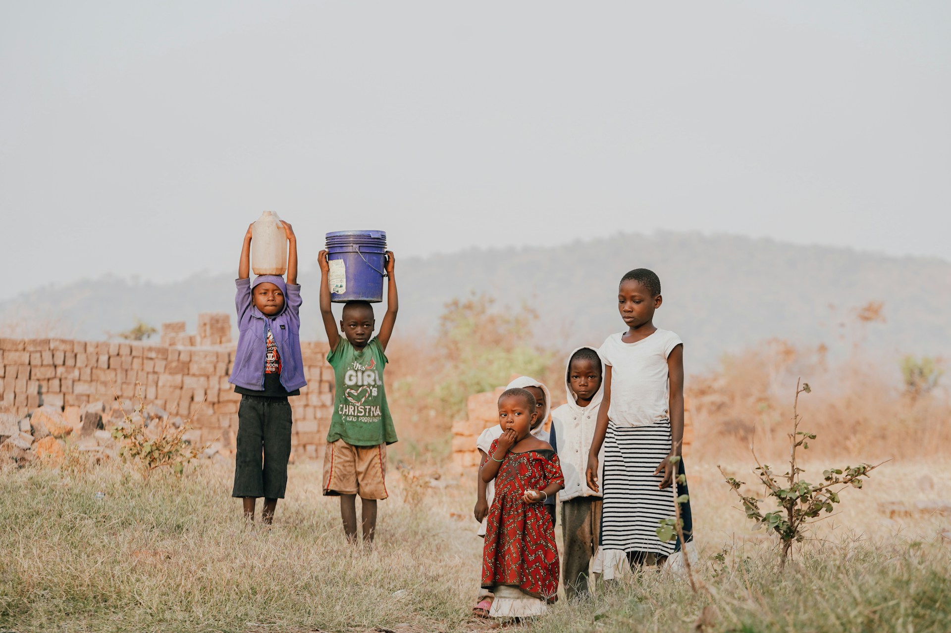 3 women standing on green grass field during daytime