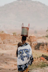 woman in white and blue floral shirt wearing red and white floral bucket hat