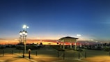A peaceful campus parking area at sunset, showing cars parked neatly in reserved spots.