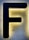 A large black letter 'F' is mounted on a textured, illuminated background that appears to be made of stone or stucco, creating a striking contrast with the surrounding light.