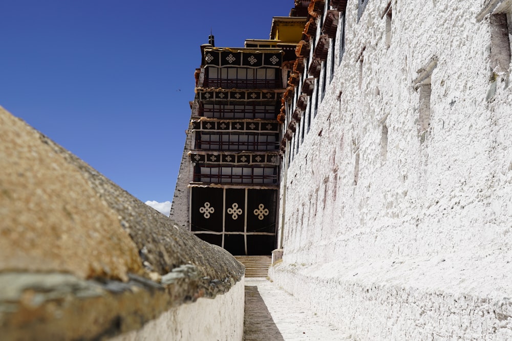 brown wooden door on white concrete building during daytime