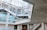 An industrial-looking architectural structure with metal beams and walkways. The design incorporates modern elements with glass windows and concrete walls. The building has various levels connected by metal stairs and pathways, creating an intricate, geometric pattern.