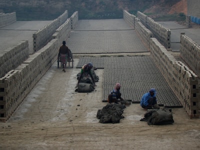 Workers inspecting bricks for quality control in the factory.