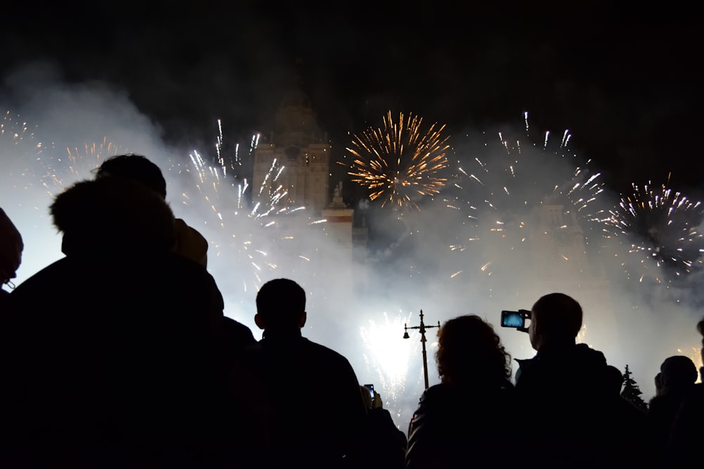 silhouette of people watching fireworks