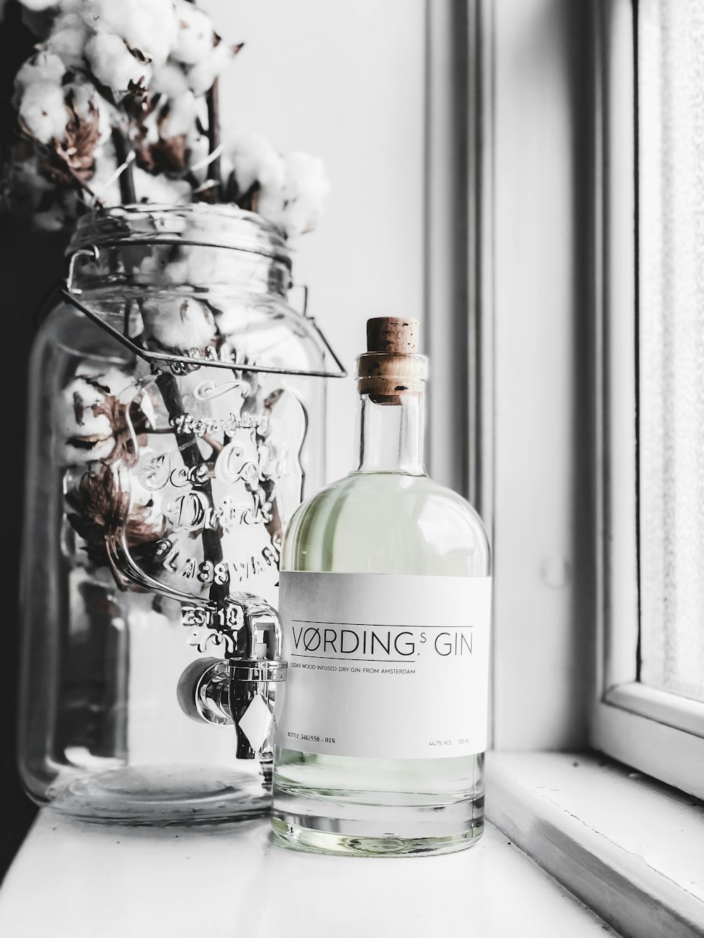 a bottle of wodding gin sitting on a window sill