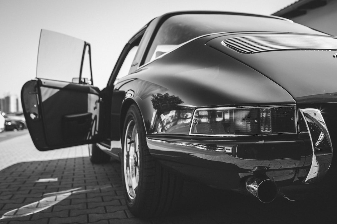 grayscale photo of car on road