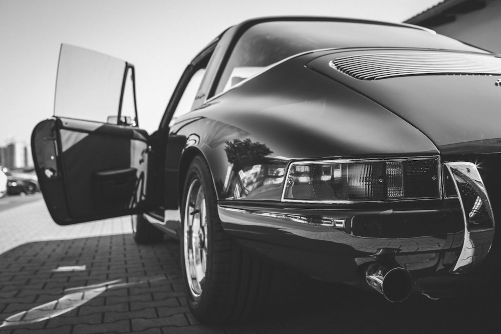 grayscale photo of car on road