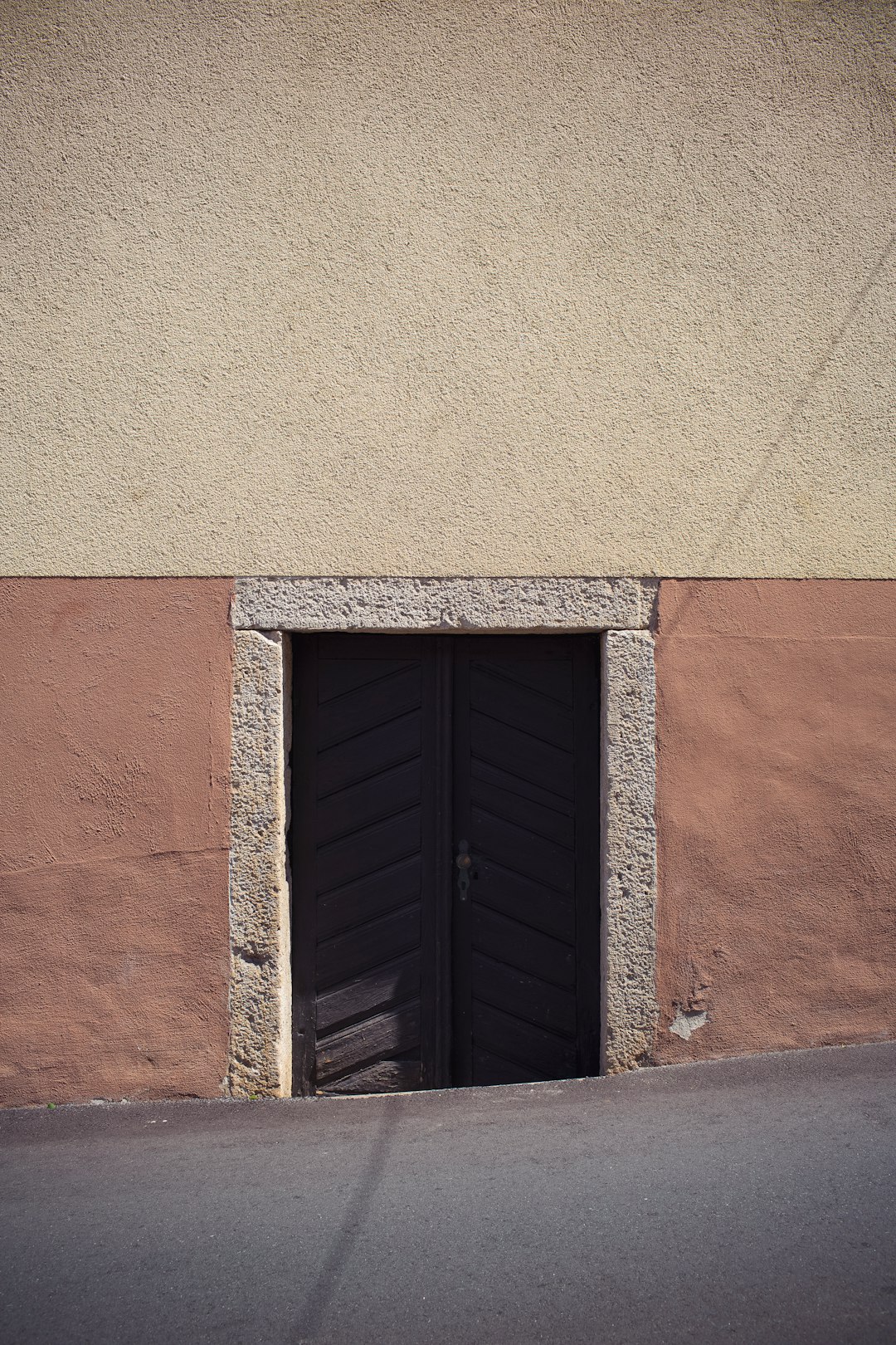 black wooden window on brown concrete wall