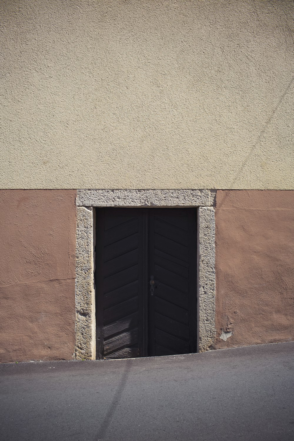 black wooden window on brown concrete wall