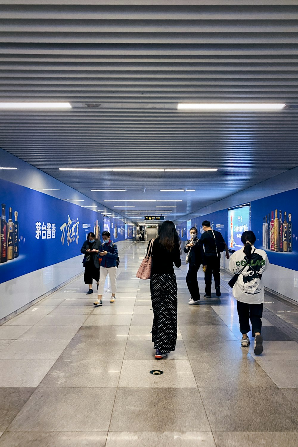 people walking on white floor tiles