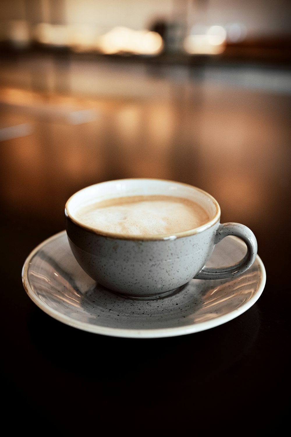 white ceramic teacup on white ceramic saucer