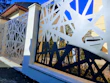A custom-designed fence blending wood and metal in a luxury home setting