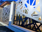 A custom-designed fence blending wood and metal in a luxury home setting