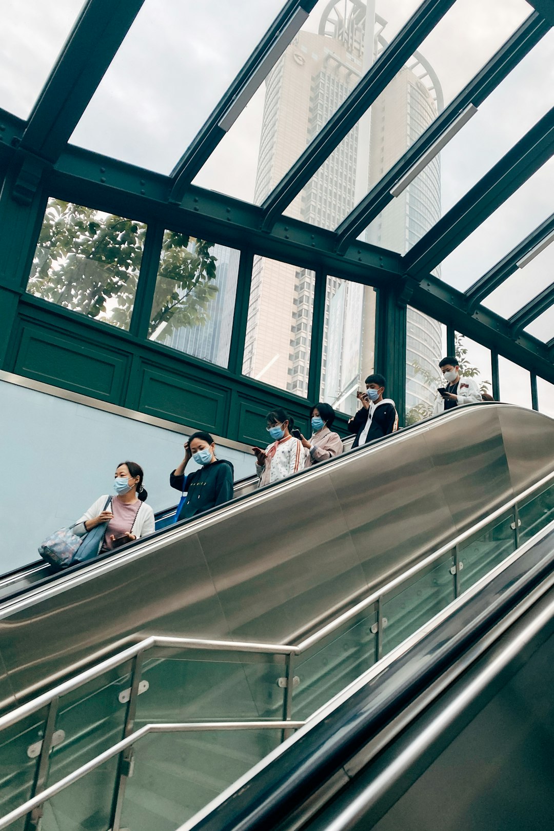 people sitting on gray escalator