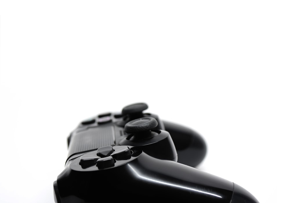 black game controller on white surface