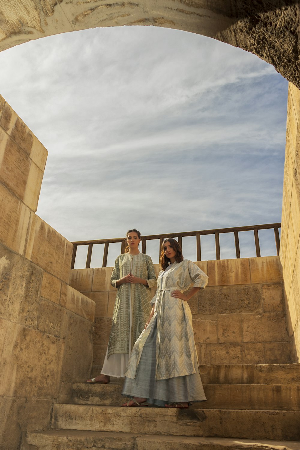 man and woman standing on brown concrete building during daytime