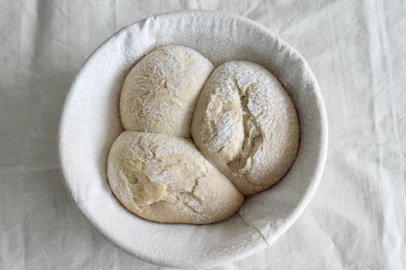 Sourdough levain being mixed with flour, water and starter in a bowl