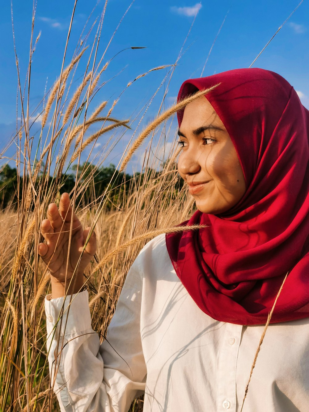 woman in white long sleeve shirt and red hijab