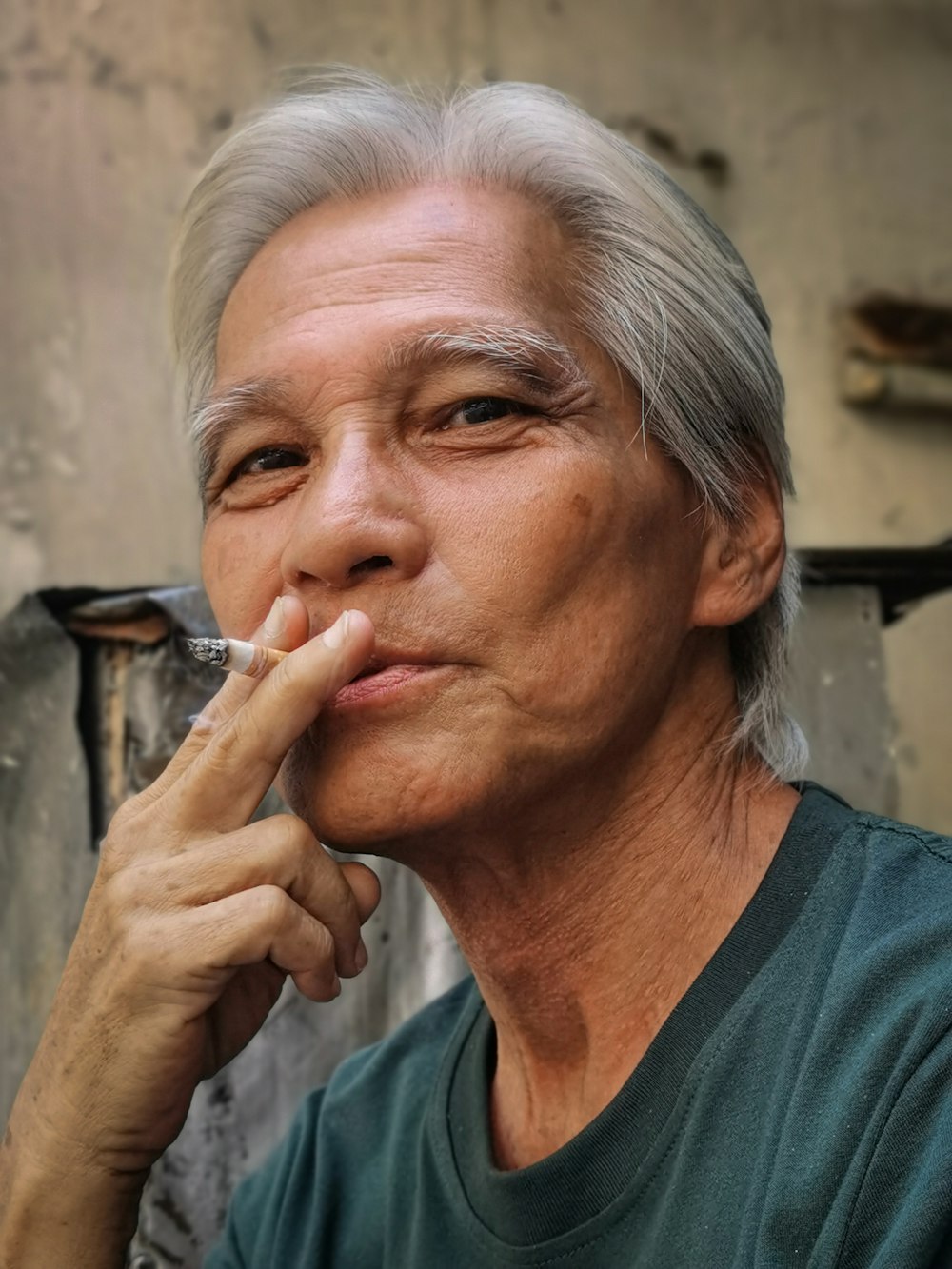 man in black v neck shirt smoking