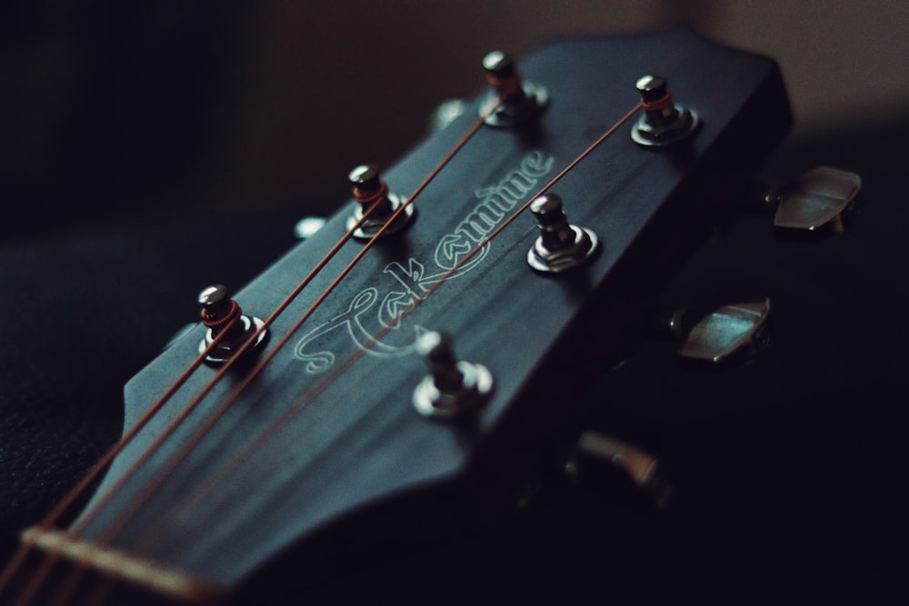 black guitar pick in close up photography