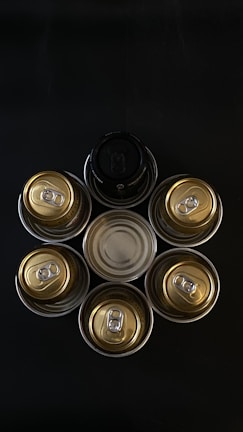 An artistic arrangement of Amethyst Beverage cans against a colorful backdrop.
