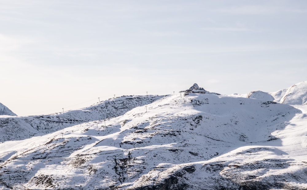 snow covered mountain under white sky during daytime