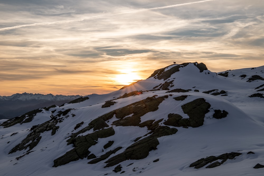 snow covered mountain during sunset