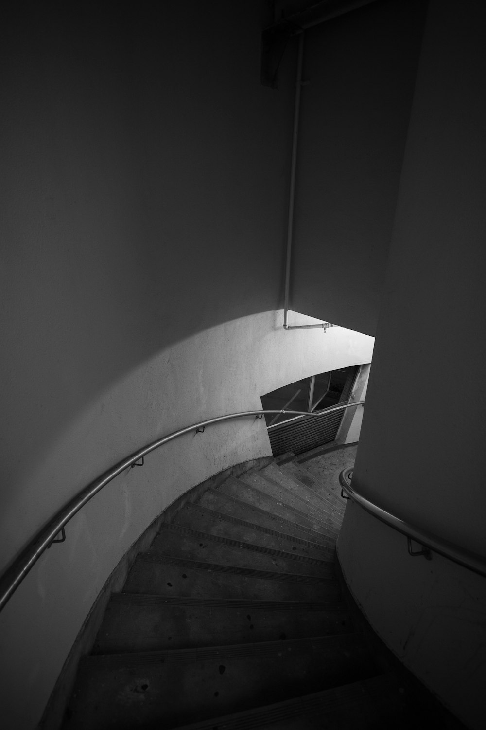 grayscale photo of staircase with railings