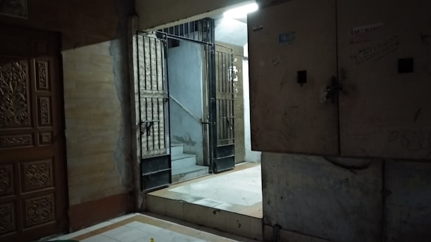 black metal gate on brown concrete wall