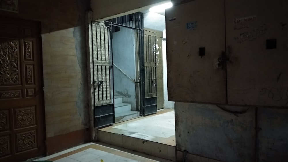 black metal gate on brown concrete wall