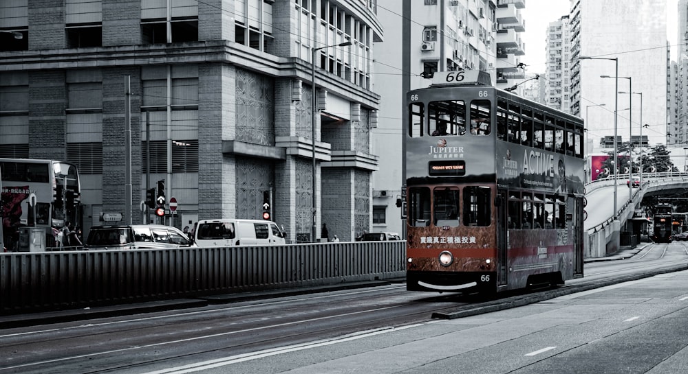 red and white tram on road near white concrete building during daytime