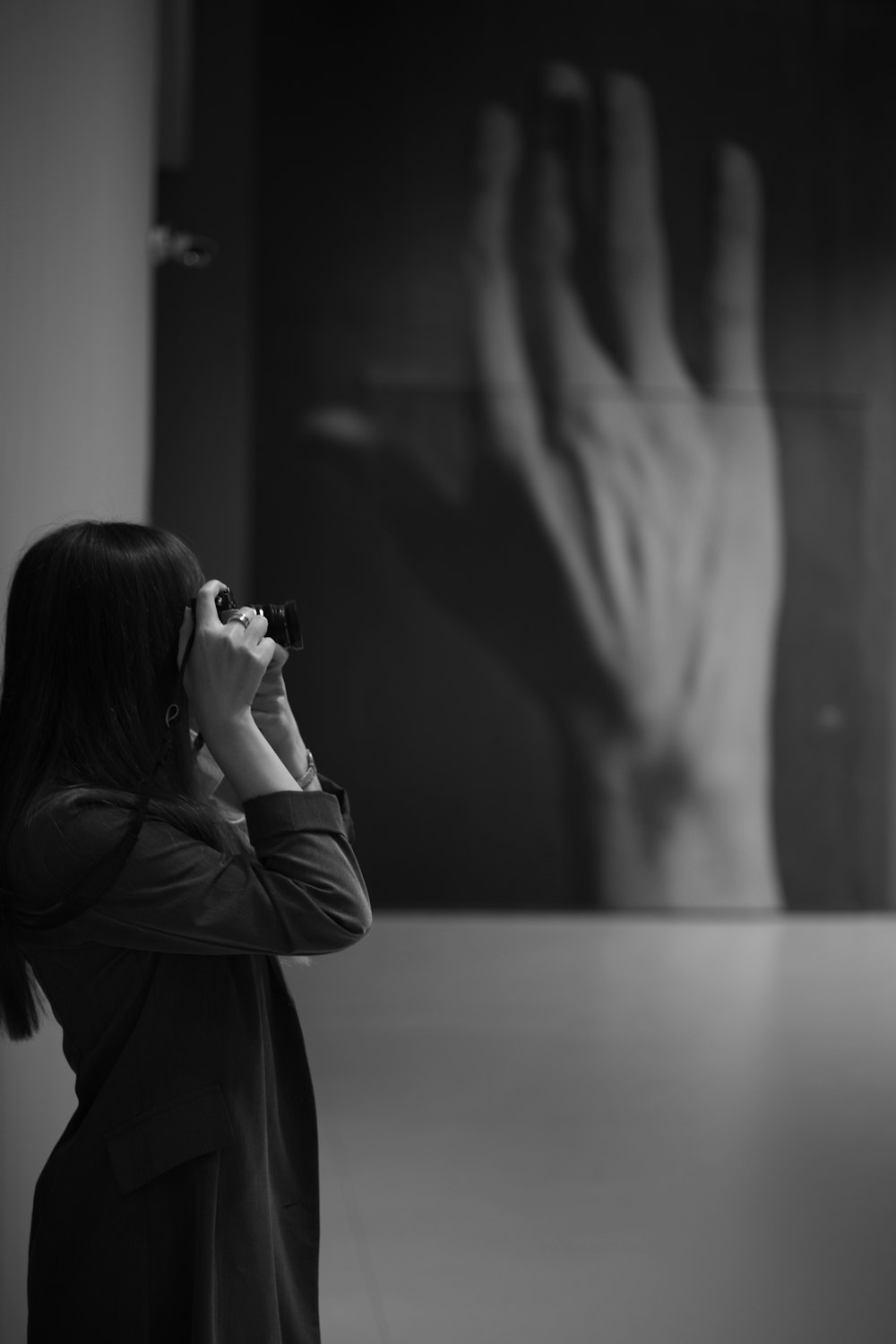 woman in black coat holding camera