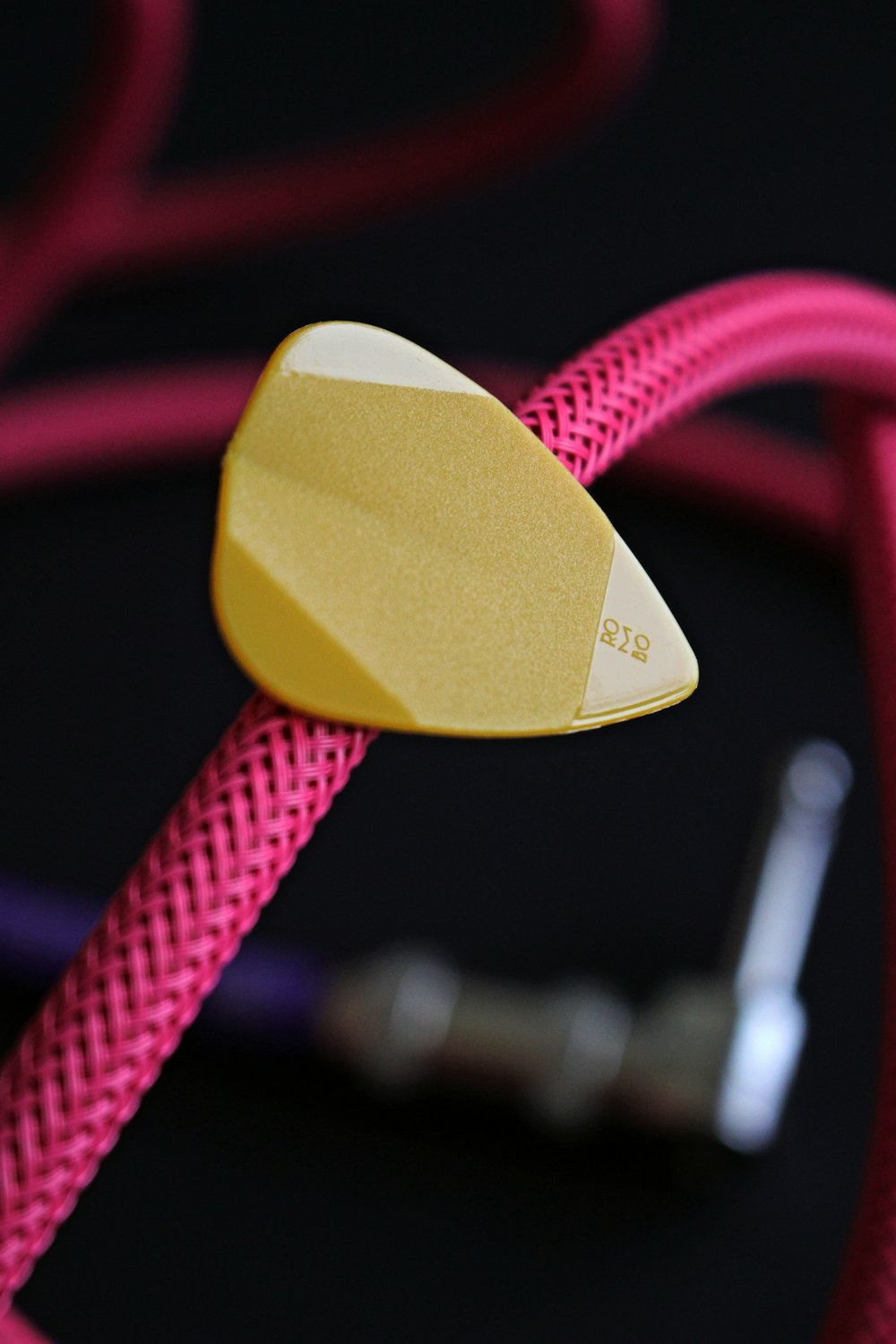 yellow heart shaped pendant on red and white rope