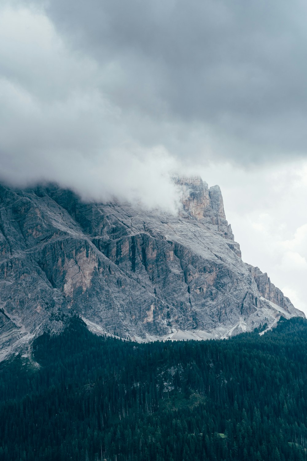 gray rocky mountain under white clouds during daytime