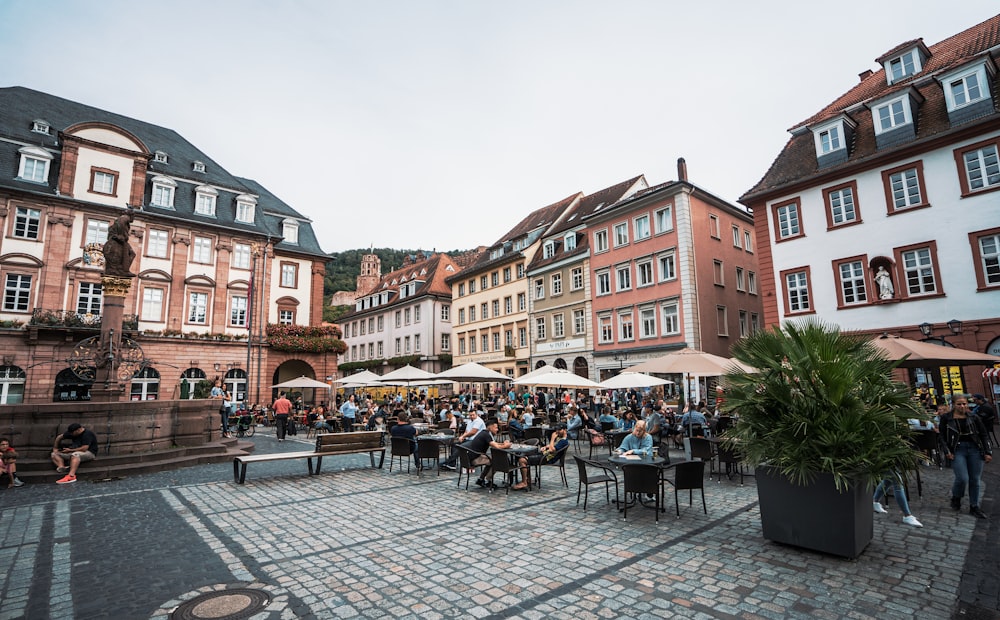 people sitting on chair near building during daytime