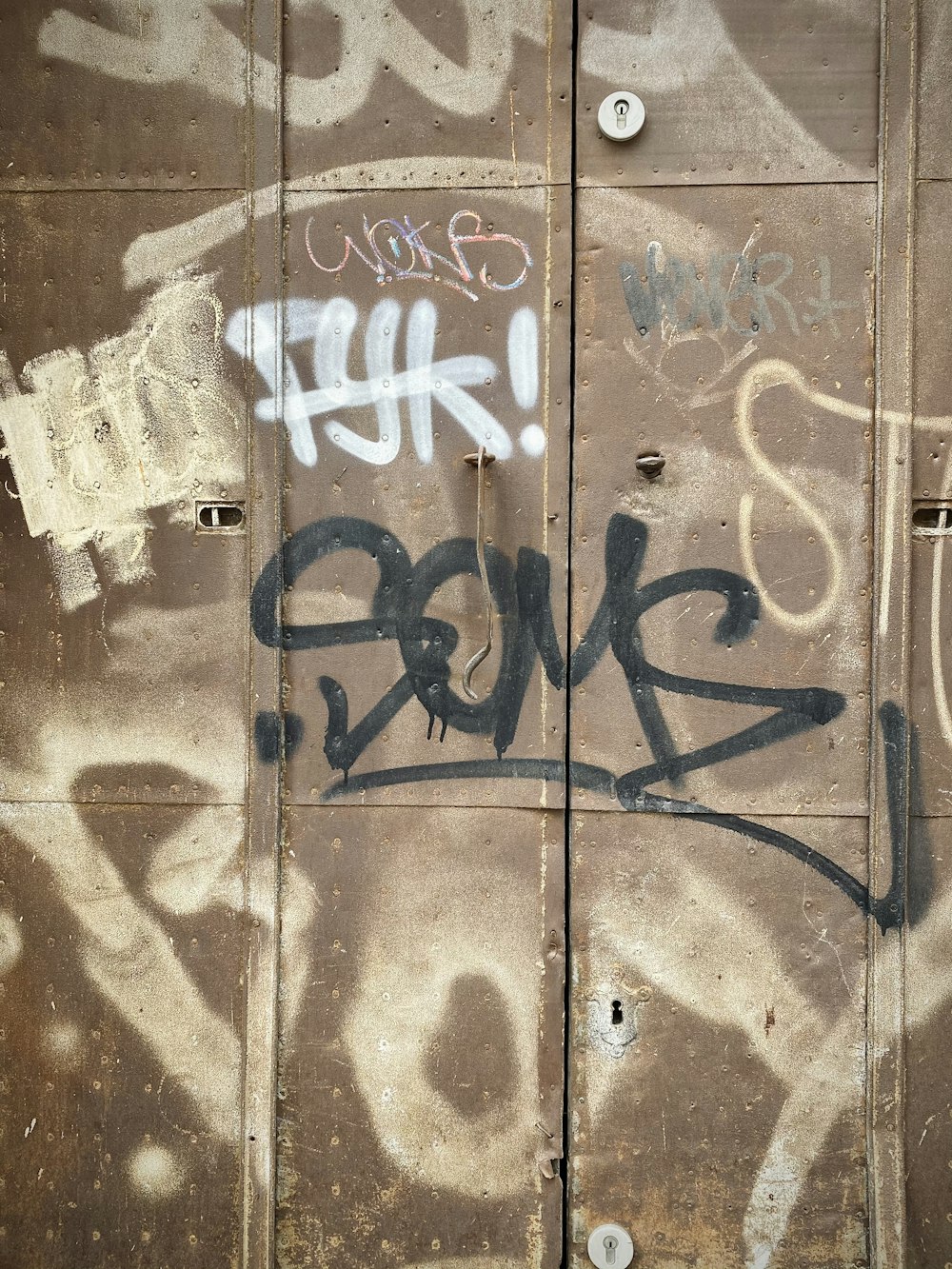 blue and white graffiti on brown wooden wall