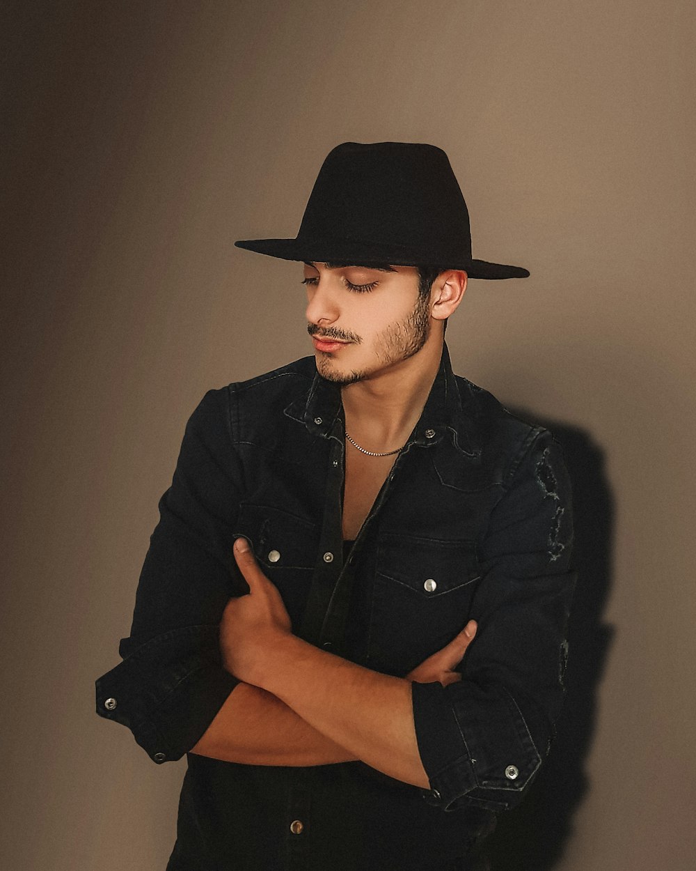 woman in black leather jacket wearing black cowboy hat