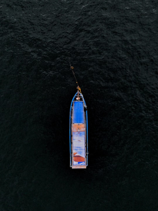 aerial view of white and blue boat on body of water during daytime in Pulau Pangkor Malaysia