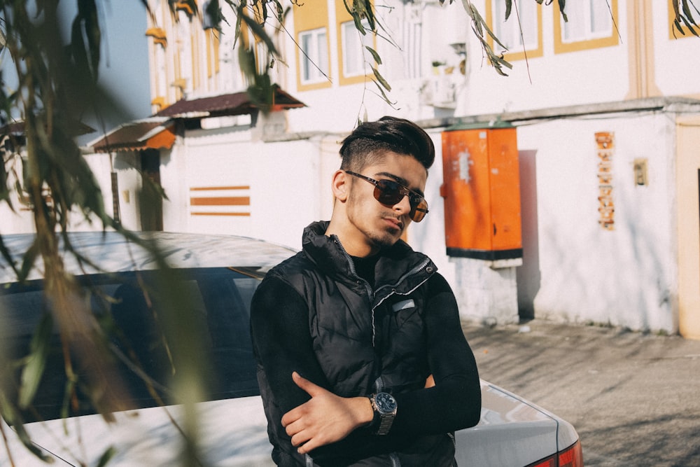 man in black leather jacket wearing black sunglasses