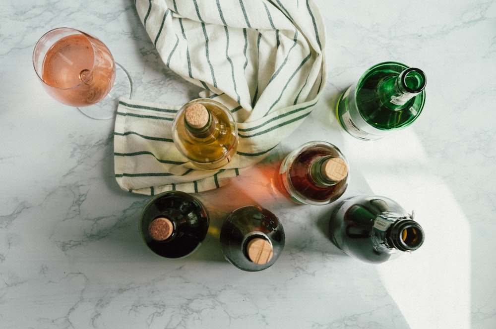 clear glass bottle on white textile