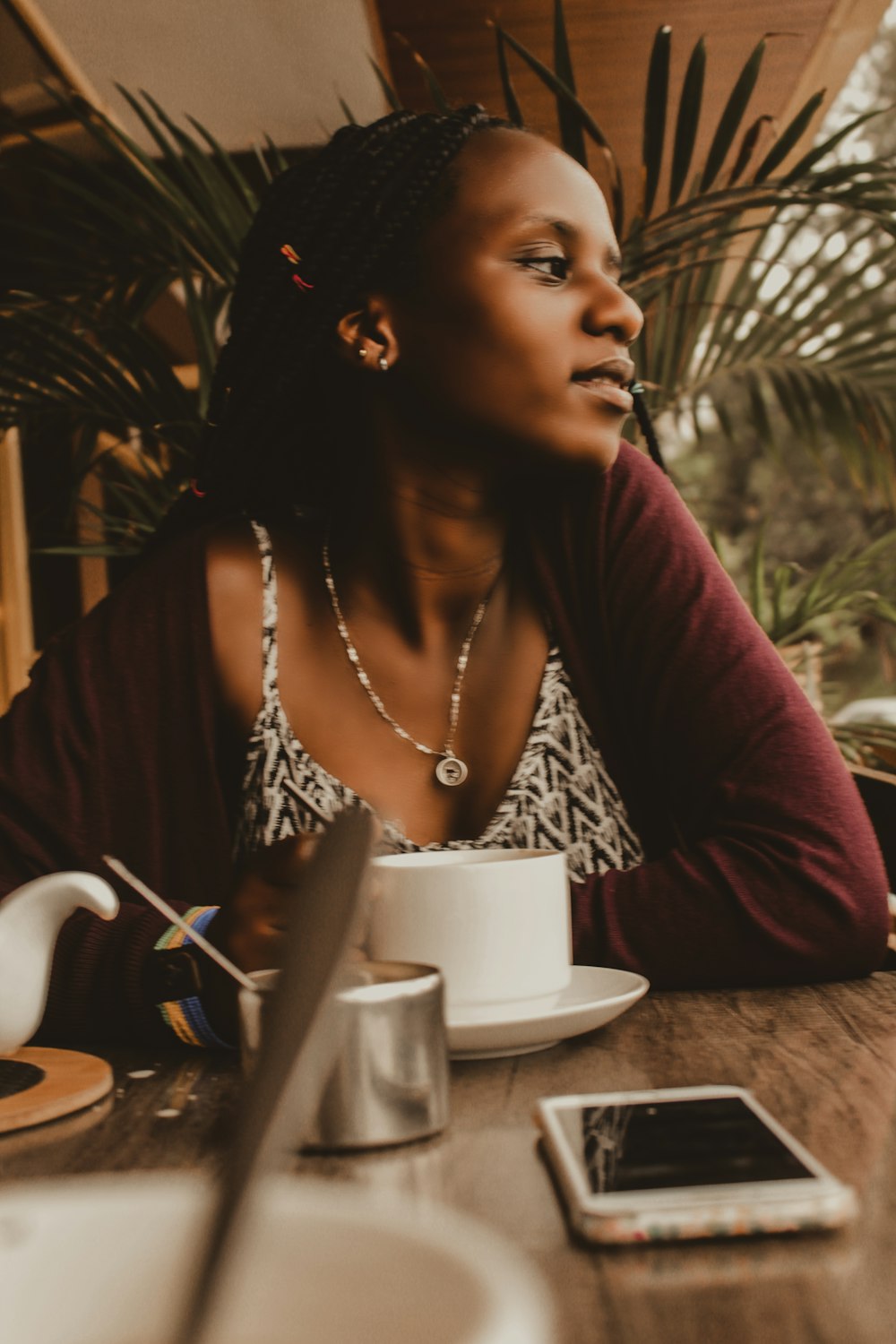 woman in black and white leopard print shirt sitting by the table