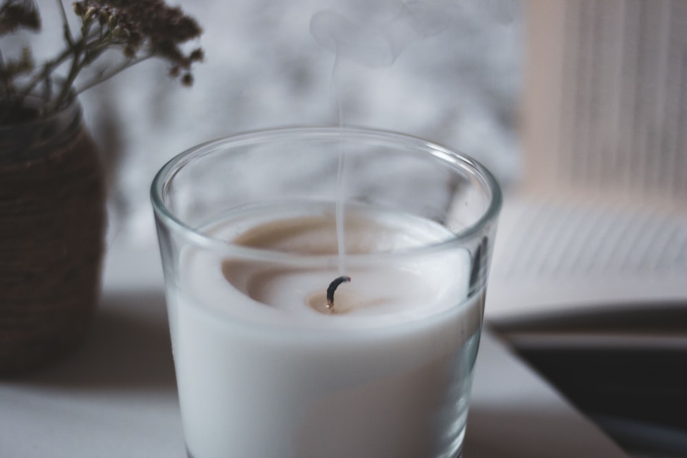 white liquid in clear drinking glass