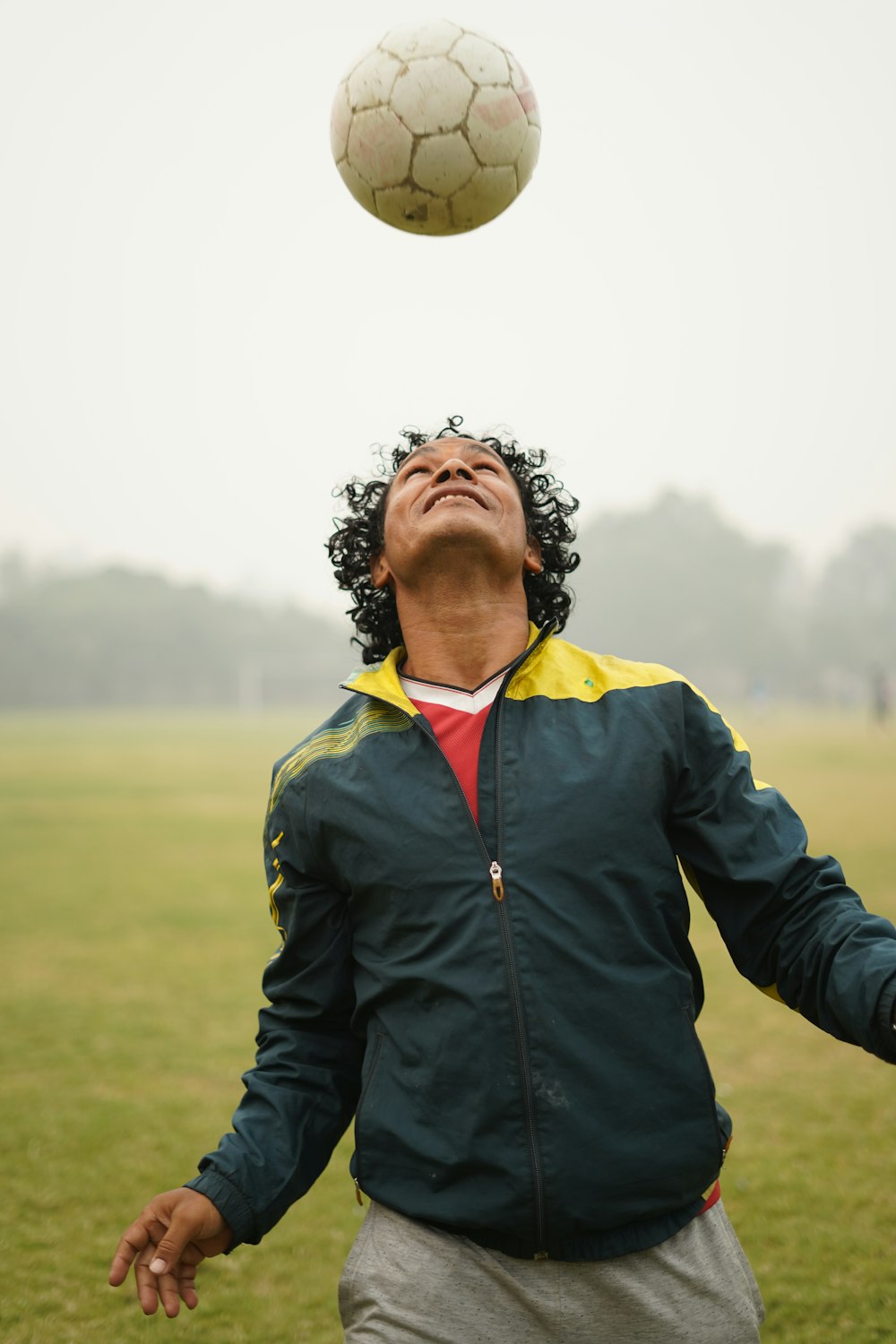 man in black jacket standing on green grass field during daytime