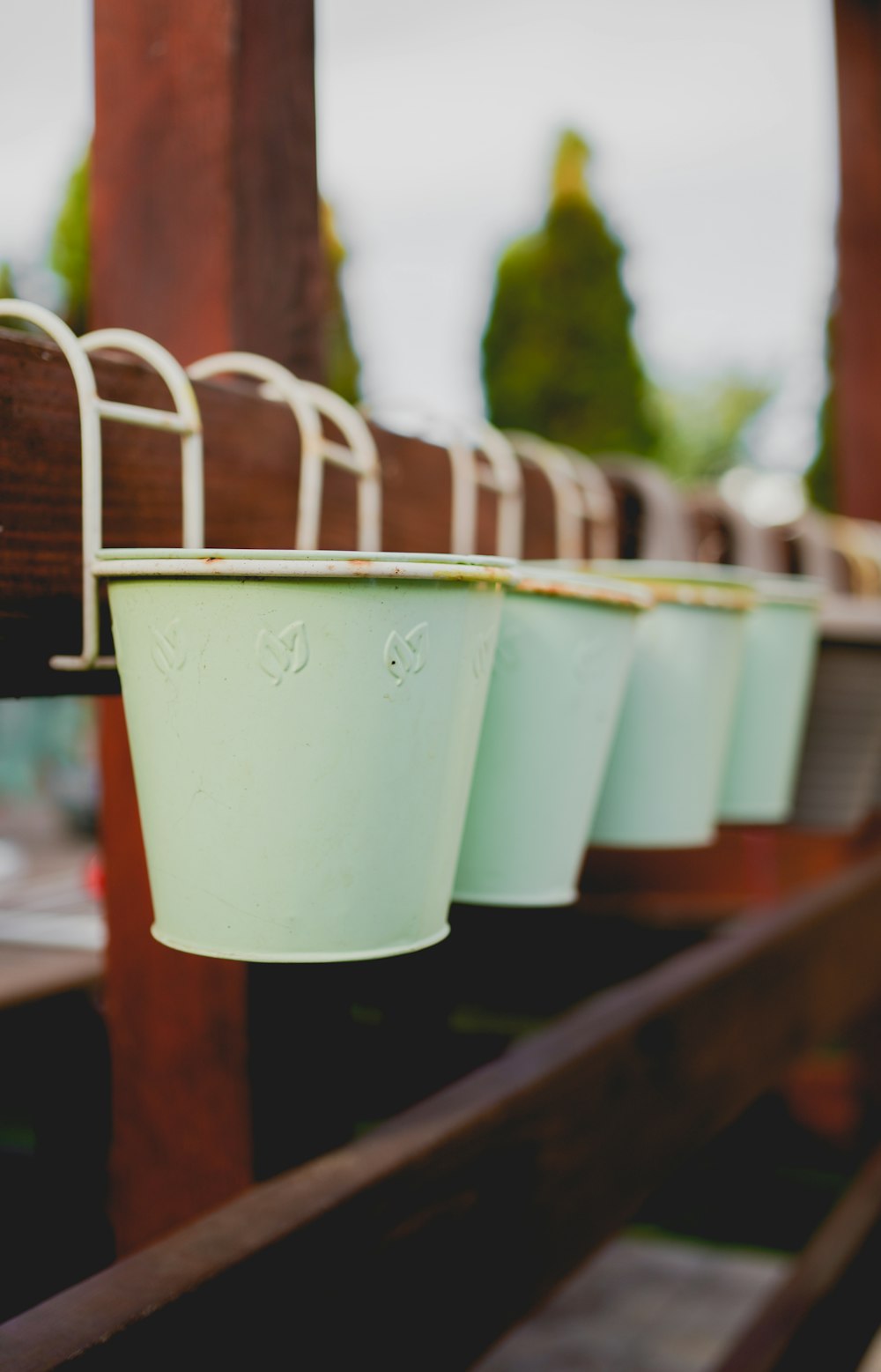 white plastic bucket on brown wooden rack