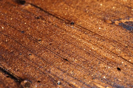 A close-up of a beautifully refinished hardwood floor reflecting light.