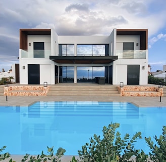 white and brown house near swimming pool